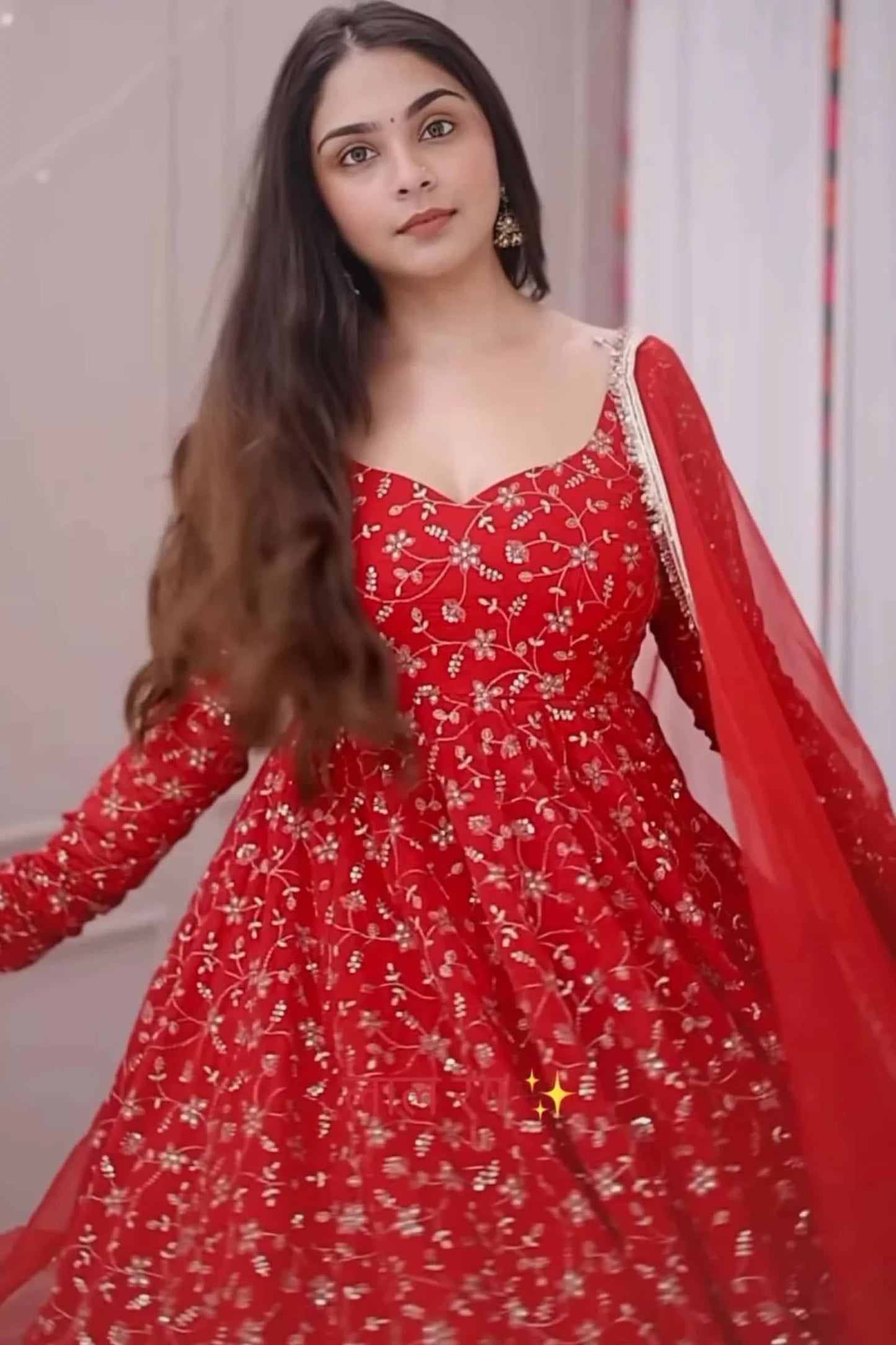 Woman wearing a red floral dress with a plain background