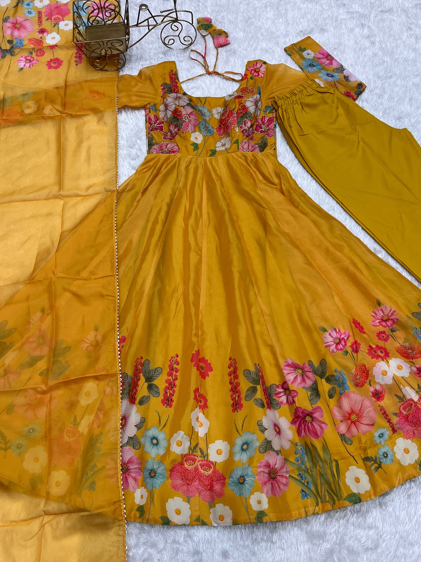 Yellow dress with floral embroidery on a white background