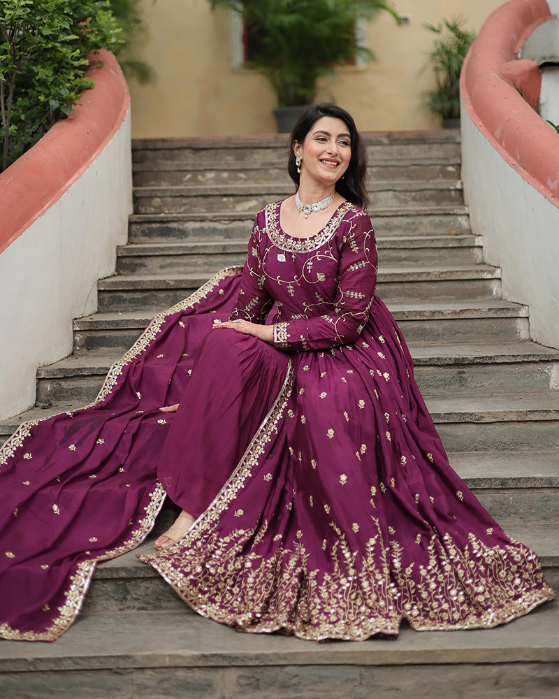 Woman in a purple traditional outfit sitting on steps outdoors