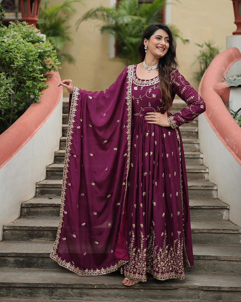 Woman in a purple traditional outfit standing on steps outdoors