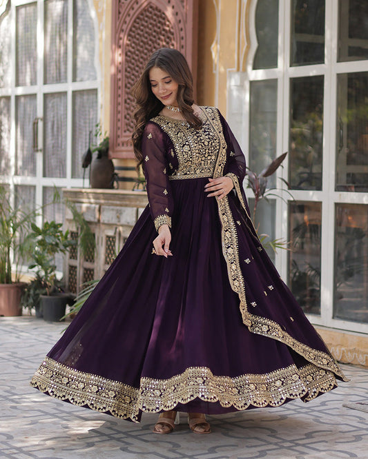 Woman wearing a purple and gold embroidered dress in an outdoor setting.
