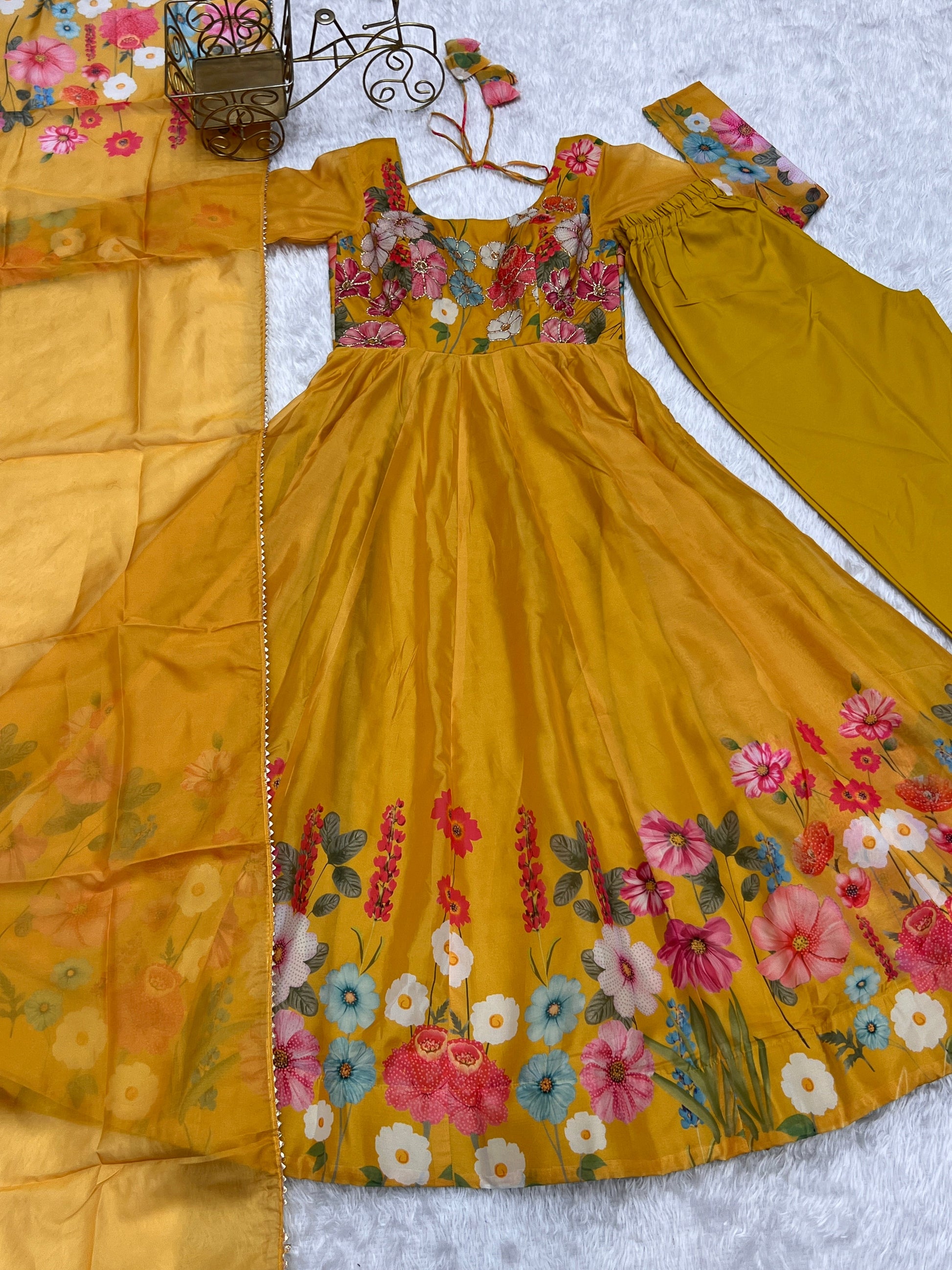 Yellow dress with floral embroidery on a white background