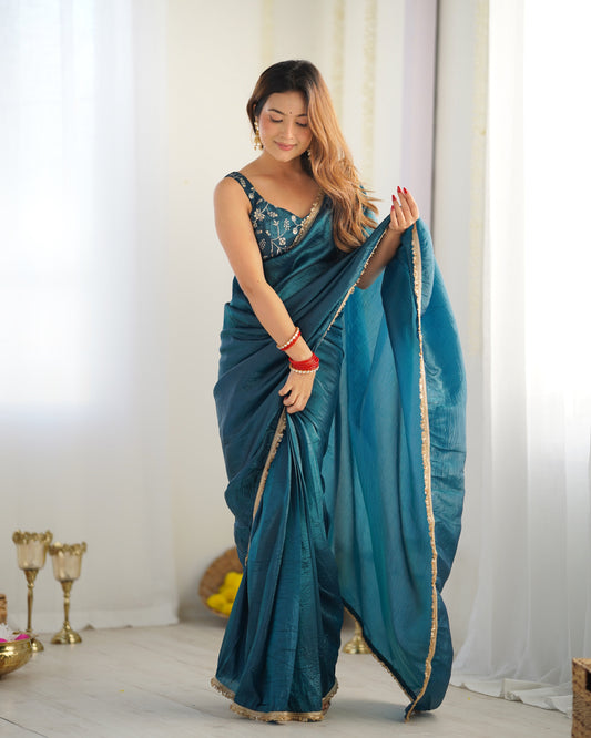Woman in a teal saree with a white background